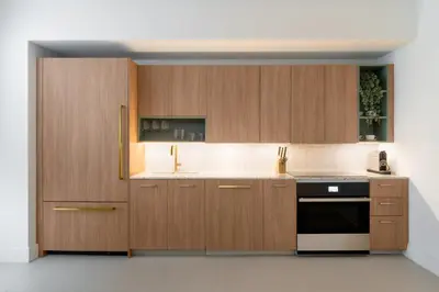 a kitchen with wooden cabinets and a black oven at Gale Miami Hotel & Residences in Miami