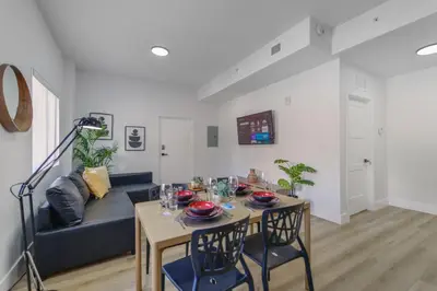 a living room with a blue couch and a table at Charming Apt Near to Stadium LoanDepot Park in Miami