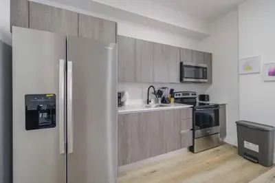a kitchen with a refrigerator and a sink at Charming Apt Near to Stadium LoanDepot Park in Miami