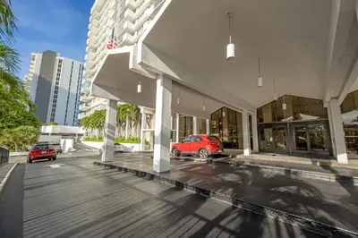a red car parked in front of a building at Pavilion Residences on the Beach in Miami Beach