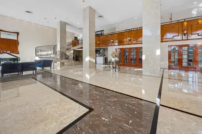 a large lobby with a large marble floor and furniture at Pavilion Residences on the Beach in Miami Beach