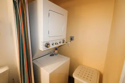 a small bathroom with a toilet and a tv on the wall at Castle Ph2 Balcony Oceanfront Condo, Beach Access, Pool, Tennis, Free Parking in Miami Beach