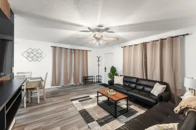 a living room with a couch and a ceiling fan at Sunrise Getaway in Sunrise
