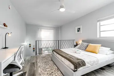 a white bedroom with a bed and a desk at Mia Airport 1b Apt with desk Virg 9 in Miami