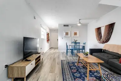 a living room with a couch and a tv and a table at Mia Airport 1b Apt with desk Virg 9 in Miami