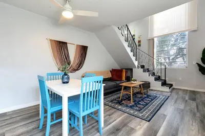 a living room with a table and chairs and a couch at Mia Airport 1b Apt with desk Virg 9 in Miami