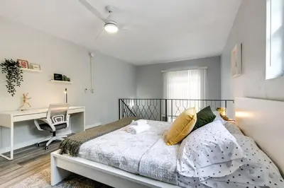a bedroom with a bed and a desk and a computer at Central 1b apt Next to Airport Virg 12 in Miami
