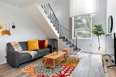 a living room with a couch and a staircase at Central 1b apt Next to Airport Virg 12 in Miami