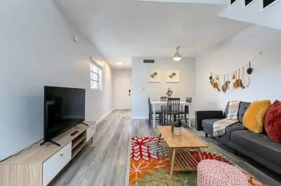 a living room with a couch and a tv at Central 1b apt Next to Airport Virg 12 in Miami