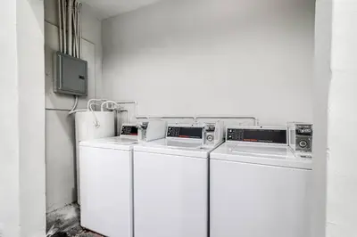 two washing machines and a tv in a room at Spacious 2 BR near Miami Airport Virg 5 in Miami