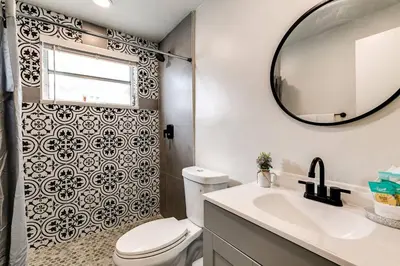 a bathroom with a toilet and a sink and a mirror at Spacious 2 BR near Miami Airport Virg 5 in Miami