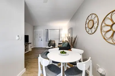 a living room with a white table and chairs at Roomy 2 BR near Miami Airport Virg 7 in Miami