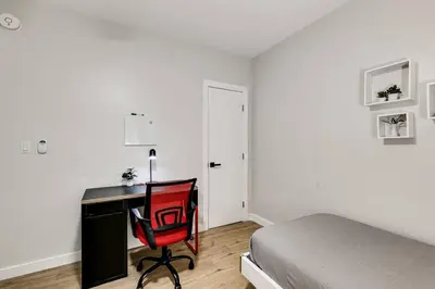 a bedroom with a desk and a bed and a red chair at Roomy 2 BR near Miami Airport Virg 7 in Miami