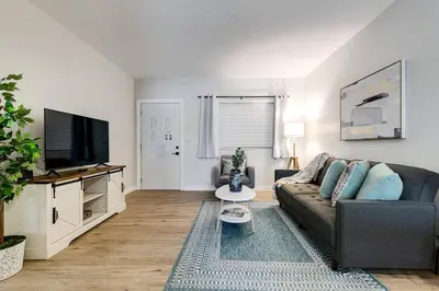 a living room with a couch and a flat screen tv at Roomy 2 BR near Miami Airport Virg 7 in Miami