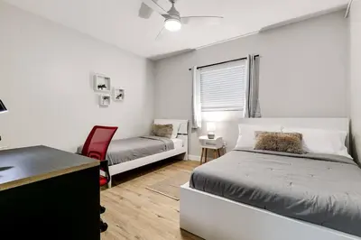 a bedroom with two beds and a desk and a chair at Roomy 2 BR near Miami Airport Virg 7 in Miami