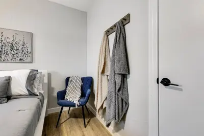 a bedroom with a blue chair next to a bed at Roomy 2 BR near Miami Airport Virg 7 in Miami