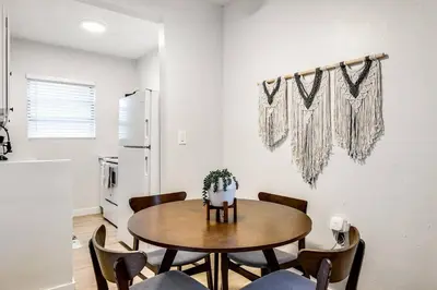 a dining room with a table and chairs at Stylish 2BR central Fast Wi fi virg2 in Miami