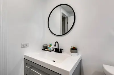a bathroom with a white sink and a mirror at Mia Springs 2BR wi-fi Virg 3 in Miami