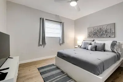 a white bedroom with a bed and a window at Mia Springs 2BR wi-fi Virg 3 in Miami