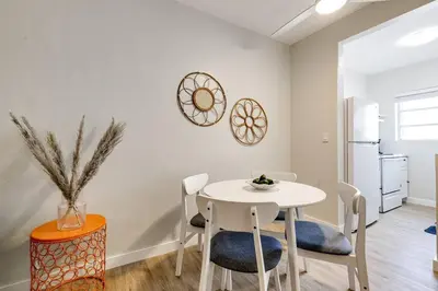 a dining room with a white table and chairs at Mia Springs 2BR wi-fi Virg 3 in Miami