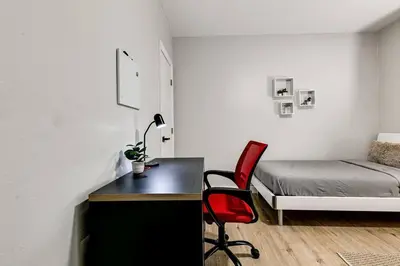 a bedroom with a desk and a bed and a chair at Mia Springs 2BR wi-fi Virg 3 in Miami