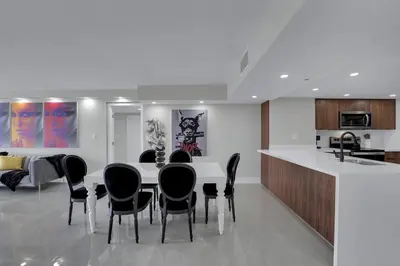 a kitchen and dining room with a table and chairs at Star Dust! Heart of Miami Dream Stay! 4 BR in Miami