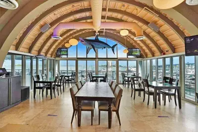 a dining room with tables and chairs and windows at Star Dust! Heart of Miami Dream Stay! 4 BR in Miami