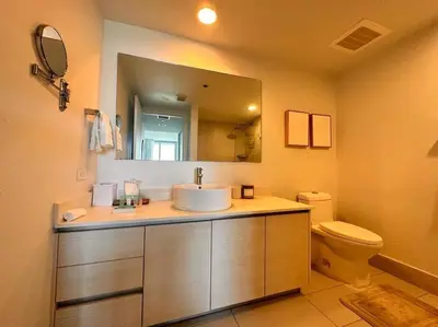 a bathroom with a sink and a toilet and a mirror at Exclusive Miami Beach Stay , Views & Modern Comfort -A in Hallandale Beach