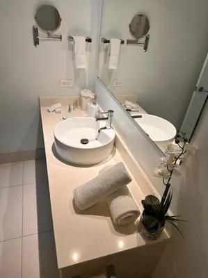 a white bathroom with a sink and a mirror at High-End Miami Condo, Ocean Views & Kitchen -A in Hallandale Beach