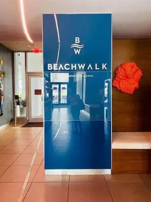 a blue sign in a building with a person on it at Feel the Miami Vibe , Cozy & Stylish Studio Stay in Hallandale Beach