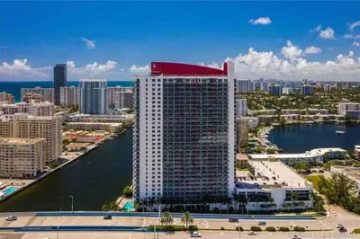 a tall building with a red roof on top of it at Feel the Miami Vibe , Cozy & Stylish Studio Stay in Hallandale Beach