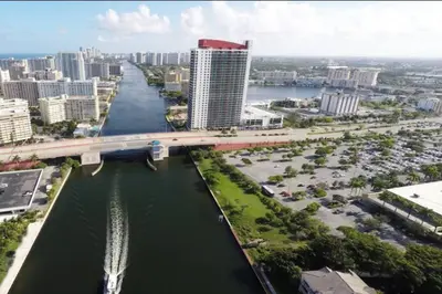 an aerial view of a city with a river and a bridge at elax & Recharge in This Incredible Miami Studio in Hallandale Beach