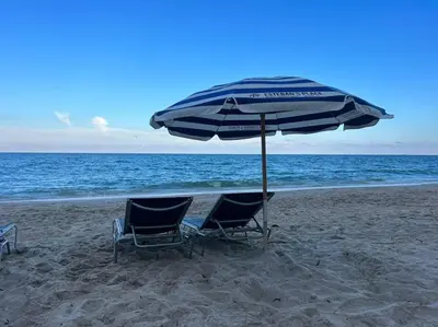 two chairs and an umbrella on the beach at Make Yourself at Home , Inviting Studio in Miami in Hallandale Beach