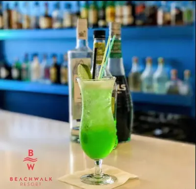 a green drink in a glass sitting on a table at Cozy Miami Studio Perfect for Vacation or Work! in Hallandale Beach