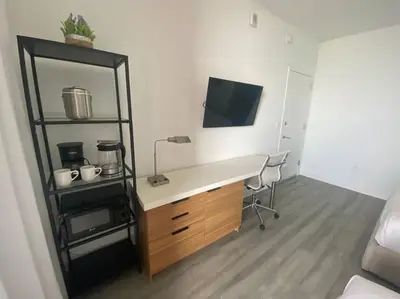 a room with a desk with a computer and a chair at Chic Studio in Miami Sleeps 4, Full Bath, Great Vibe in Hallandale Beach