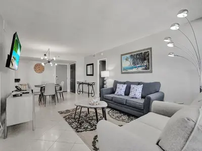 a living room with a couch and a table at Cozy Beachfront 2 BDR Miami Beach Condo 406 in Miami Beach