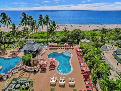 an aerial view of a resort with a pool and the beach at Cozy Beachfront 2 BDR Miami Beach Condo 406 in Miami Beach
