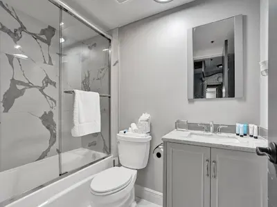 a bathroom with a toilet and a shower and a sink at Cozy Beachfront 2 BDR Miami Beach Condo 406 in Miami Beach