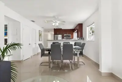 a dining room and kitchen with a table and chairs at Lakeside Retreat with Private Yard & Kayak in Fort Lauderdale