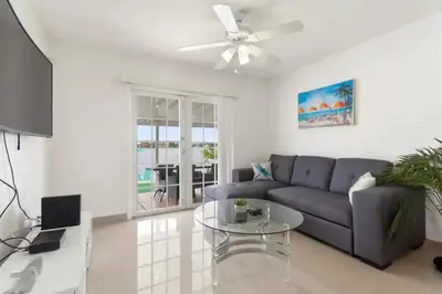 a living room with a couch and a table at Lakeside Retreat with Private Yard & Kayak in Fort Lauderdale