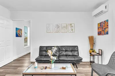 a living room with a leather couch and a coffee table at Hallandale Mins From Beach & Aventura Mall Hn01 in Hallandale Beach