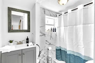 a bathroom with a shower curtain and a sink at Boutique Vacation Studio - Beach, Mall, Casino Hn2 in Hallandale Beach