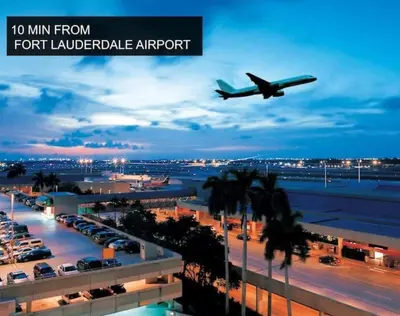 an airplane is flying low over an airport at Private Heated Pool Villa in FTL Near Beach in Fort Lauderdale