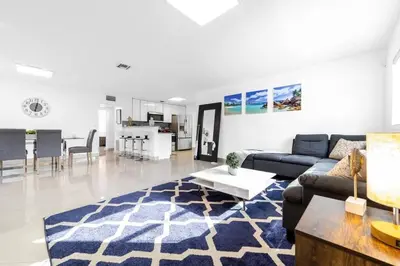 a living room with a couch and a table at Private Heated Pool Villa in FTL Near Beach in Fort Lauderdale