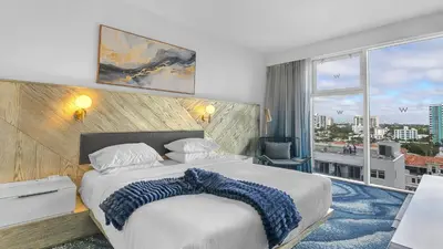 a bedroom with a large bed and a large window at Your Private Oceanfront Sanctuary 2BR 2BA in Fort Lauderdale