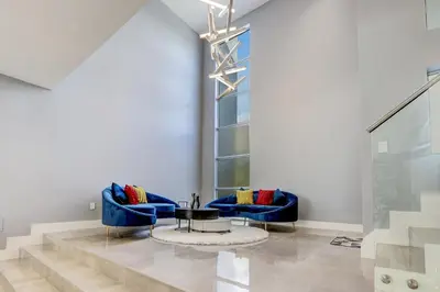 a lobby with two blue couches and a table at Deco Delight - Central Hub in Miami
