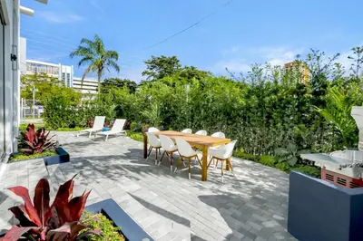a patio with a wooden table and chairs at Deco Delight - Central Hub in Miami