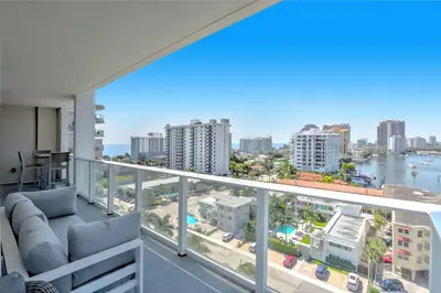 an apartment balcony with a view of the ocean at Tiffany Hazel - Rooftop Pool, Gym, & Walk to Beach in Fort Lauderdale
