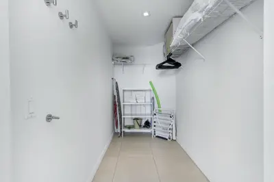 a hallway with white walls and a white floor at Tiffany Ebony - Ocean & Canal views, Walk to Beach in Fort Lauderdale