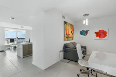 a living room with a couch and a table at Tiffany Ebony - Ocean & Canal views, Walk to Beach in Fort Lauderdale